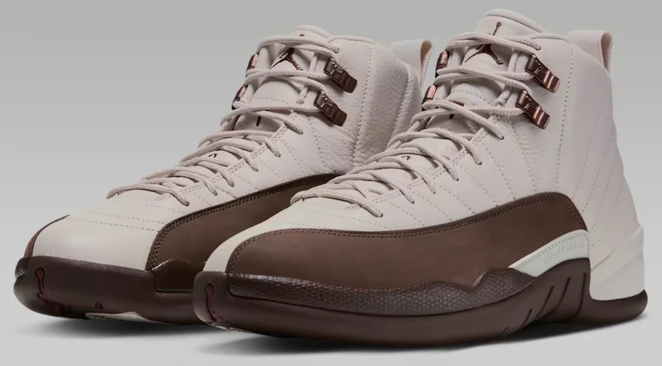 Pair of Air Jordan 12 Fireside sneakers featuring Light Orewood Brown leather uppers, Cacao Wow mudguards and metallic lace hooks