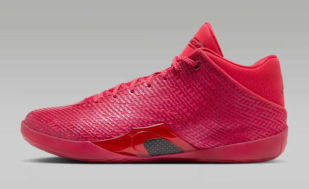 Air Jordan 41 Ruby basketball shoe featuring a vibrant red upper, textured geometric detailing, matching red laces and a sculpted red midsole, shown from the side.