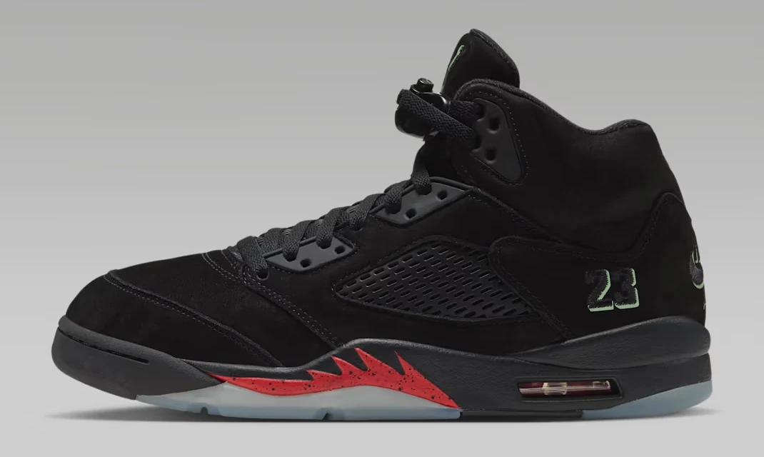 Air Jordan 5 Halloween 2026 black sneaker with red midsole accents and translucent outsole, shown from the side.
