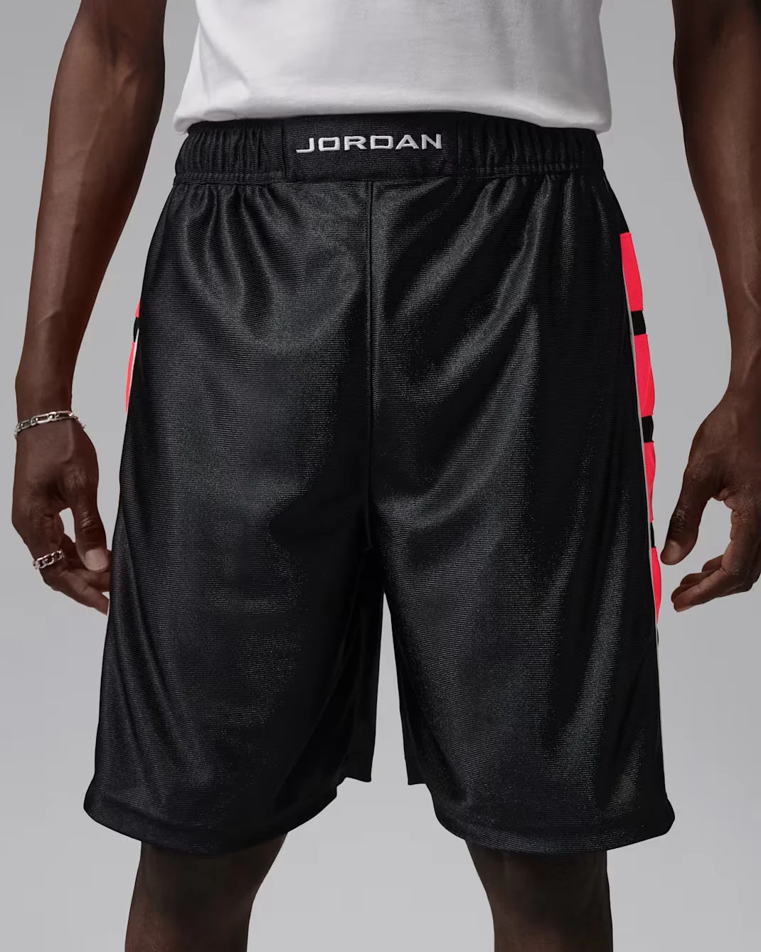Black Jordan Essentials Cat Scratch basketball shorts with Infrared side graphics and white Jordan waistband lettering, matching the Air Jordan 6 White Infrared.