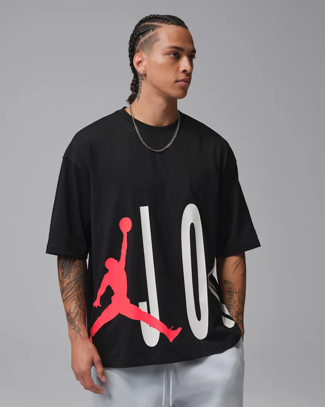 Front view of black Jordan Torso Stretch Oversized T-Shirt with large white lettering and Infrared Jumpman graphic, matching the Air Jordan 6 White Infrared sneakers.