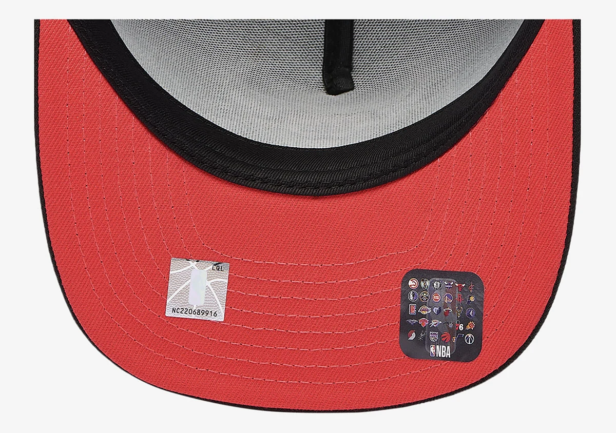Underbrim view of New Era Chicago Bulls black snapback showing red undervisor, black stitching and NBA authenticity sticker, matching the Air Jordan 6 White Infrared.