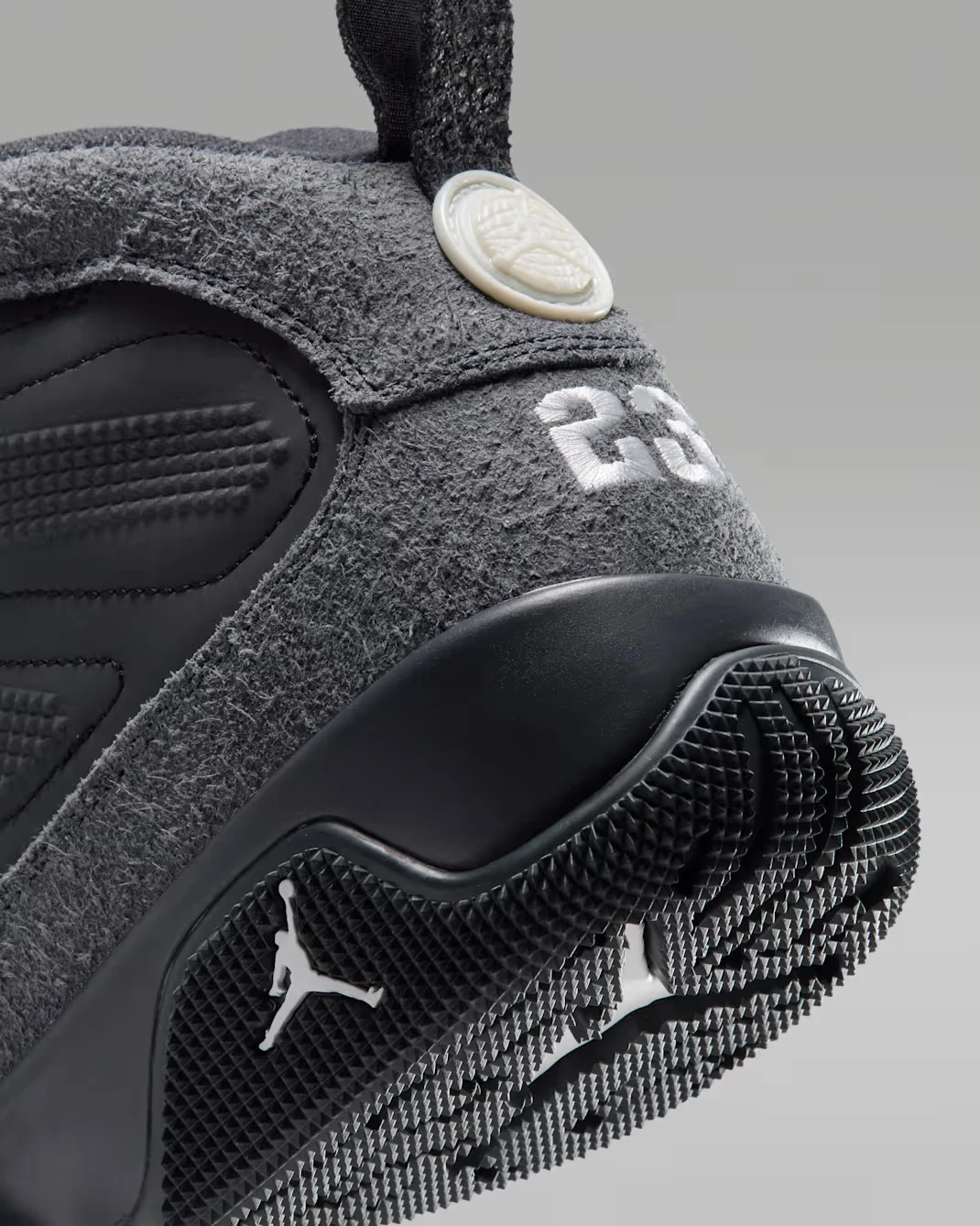 Close-up of the Air Jordan 9 Retro Boot Anthracite Reflective heel featuring grey textured material, white 23 embroidery and black traction.