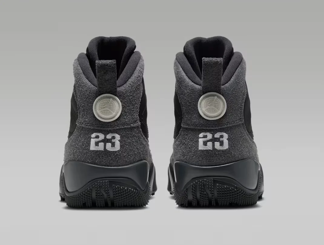 Rear view of the Air Jordan 9 Retro Boot Anthracite Reflective pair with grey heels, white 23 embroidery and circular heel emblems.