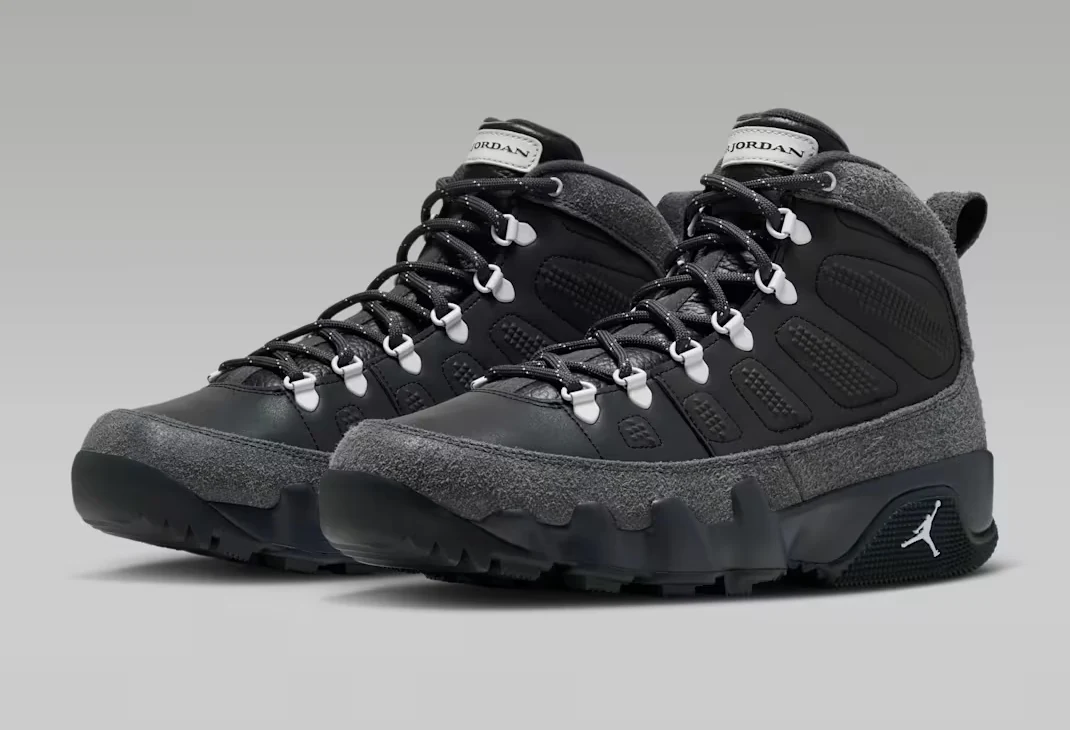Three-quarter view of the Air Jordan 9 Retro Boot Anthracite Reflective pair showing black uppers, grey overlays and rugged soles.
