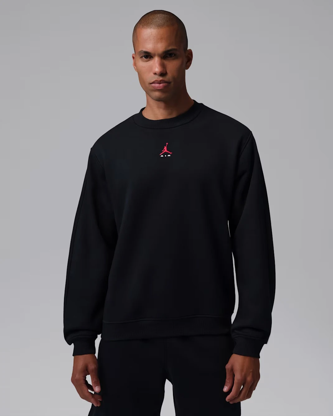 Black Jordan Brooklyn crew-neck sweatshirt with small red Jumpman Air chest logo