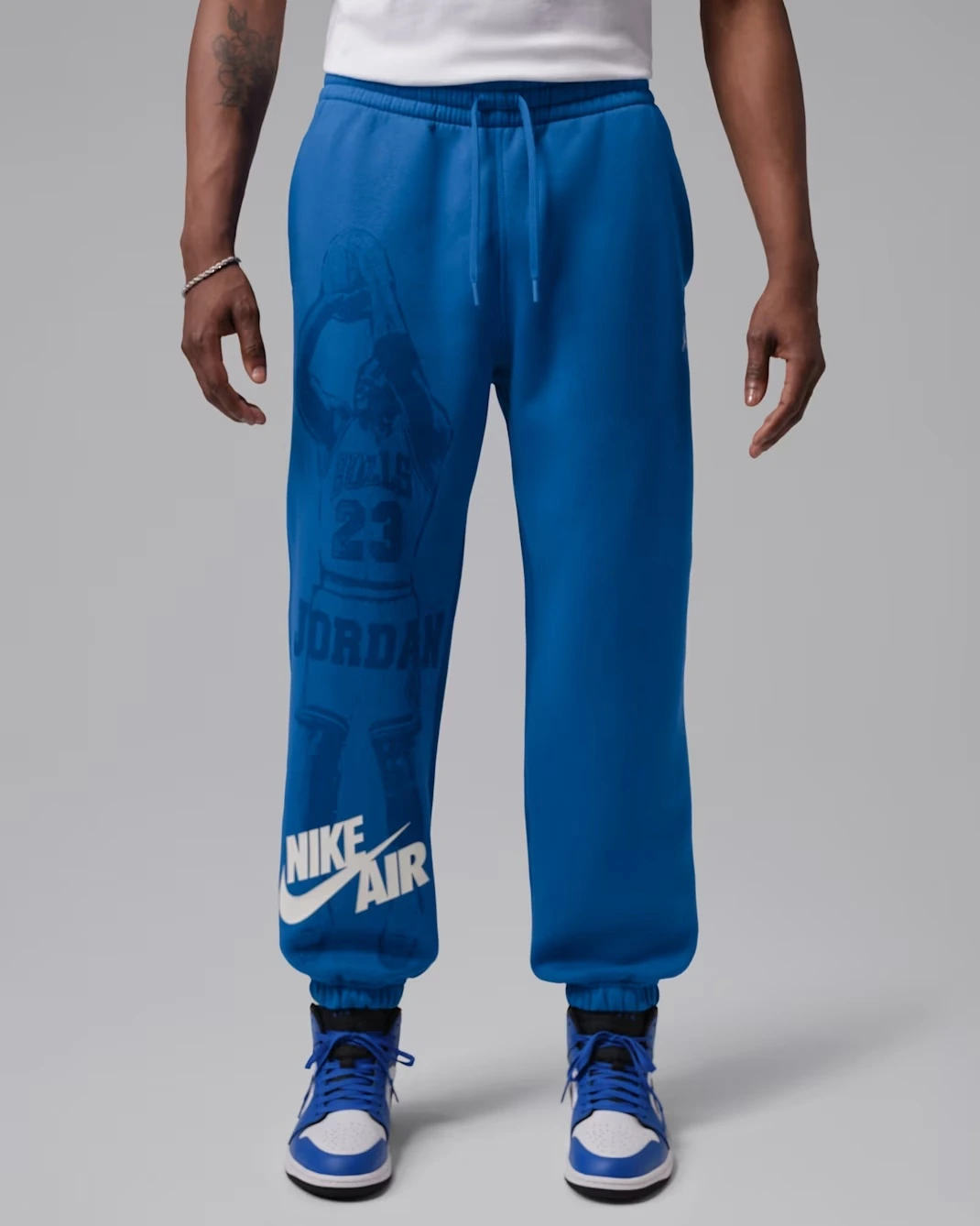 Royal blue Jordan Brooklyn Fleece cuffed pants with Nike Air branding and Jordan graphic