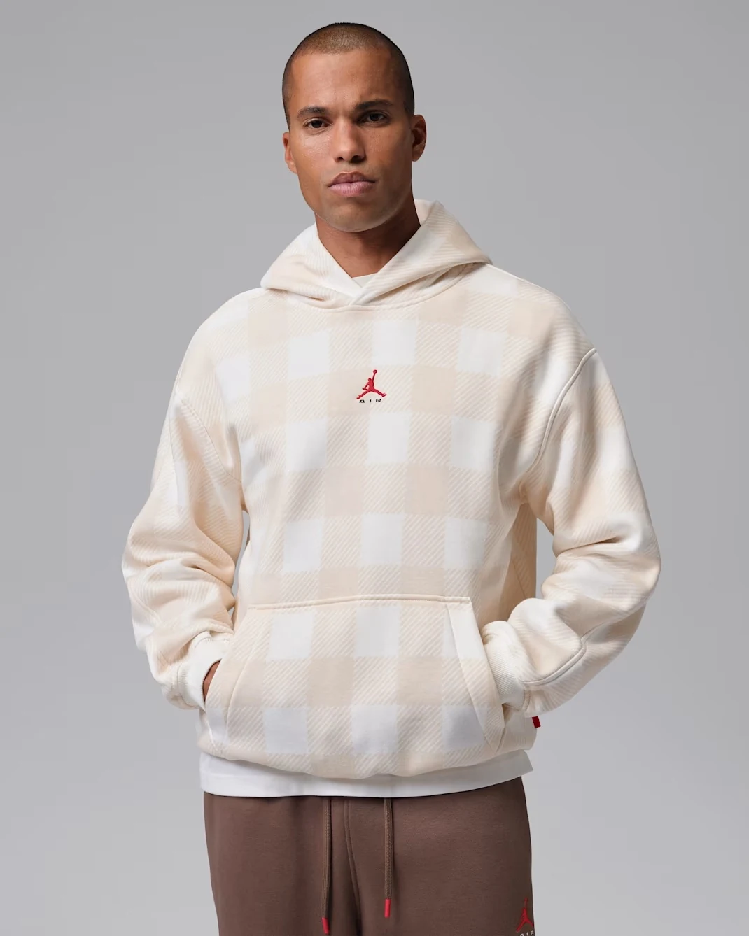 Model wearing Sail Jordan Brooklyn pullover hoodie with tonal checkered pattern