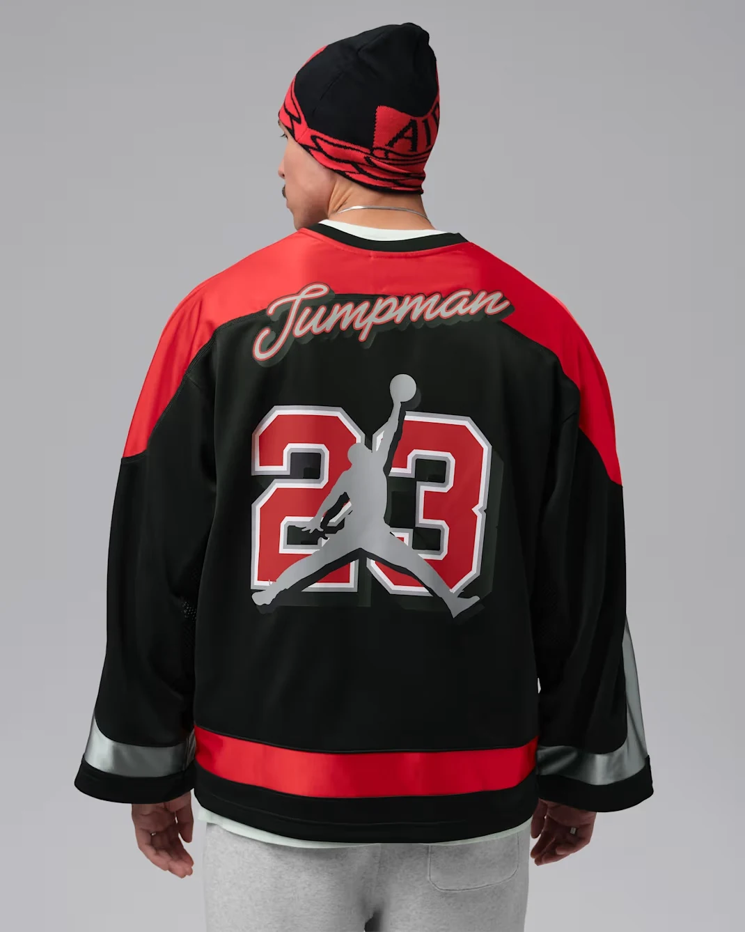 Back of black and red Jordan Brooklyn hockey jersey with Jumpman script and number 23 graphic