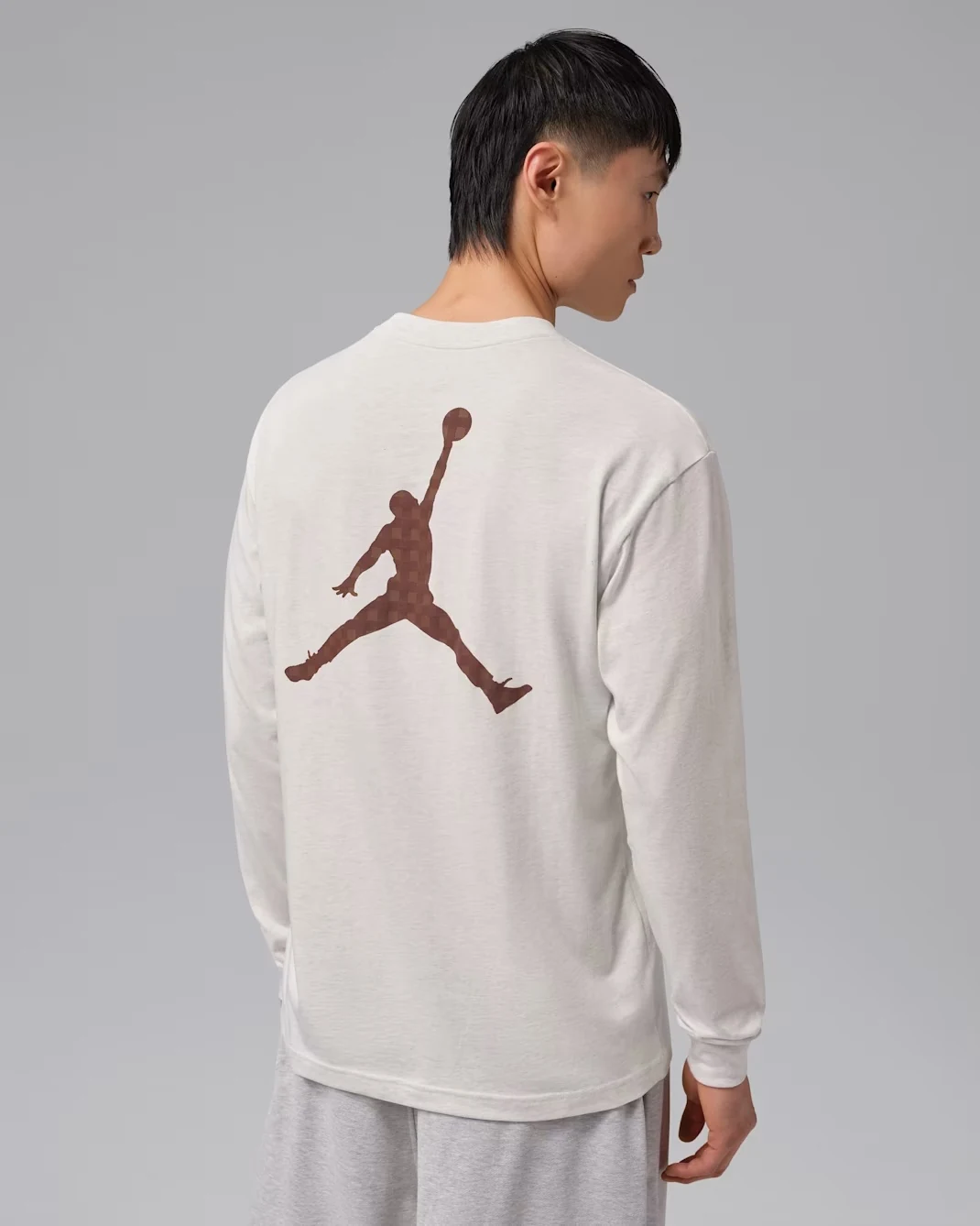 Back view of Jordan Brooklyn long-sleeve T-shirt in Sail with large brown Jumpman graphic