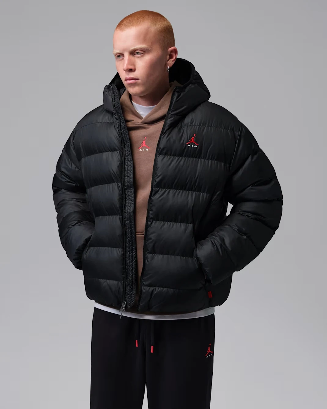 Black Jordan Brooklyn puffer jacket with red Jumpman Air logo on the chest