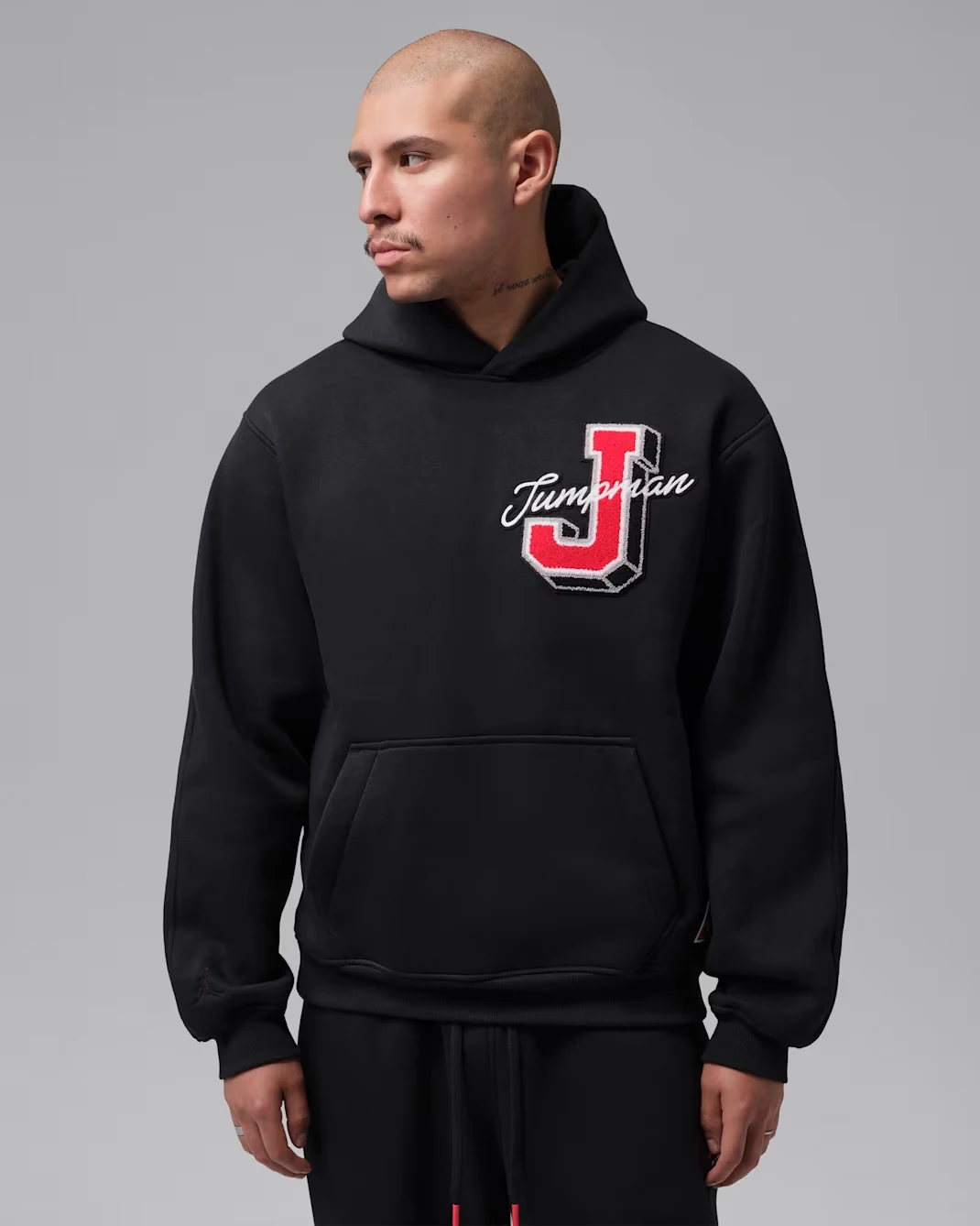 Black Jordan Brooklyn Statement pullover hoodie with red and white Jumpman J chest patch