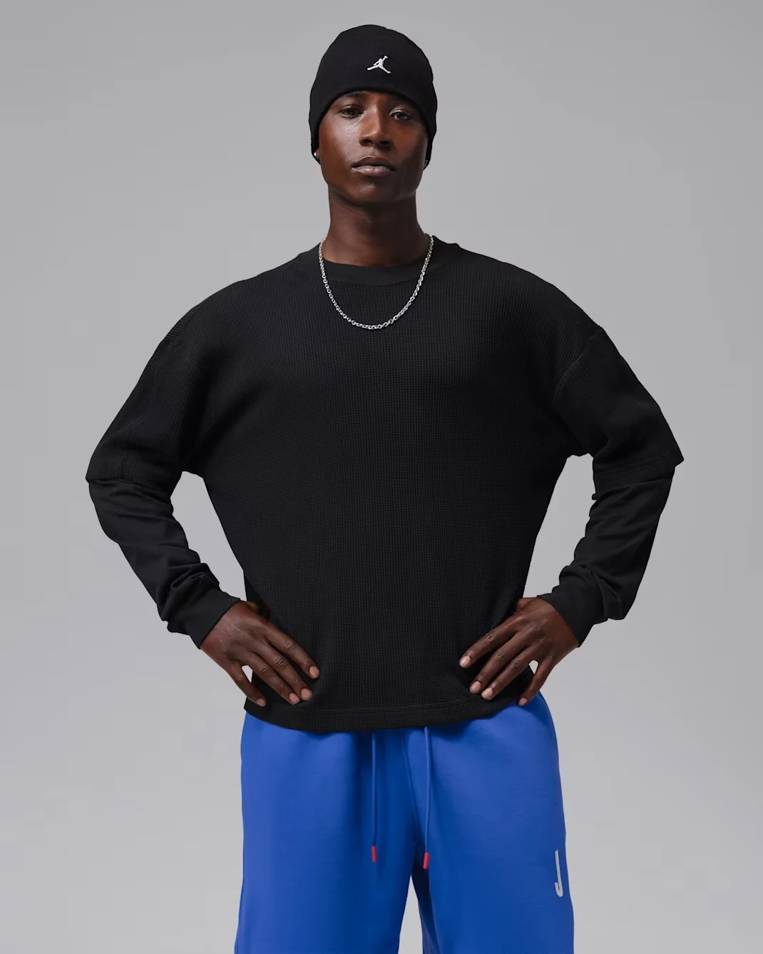 Model wearing a black Jordan Brooklyn waffle crew-neck sweatshirt with textured fabric and relaxed sleeves.