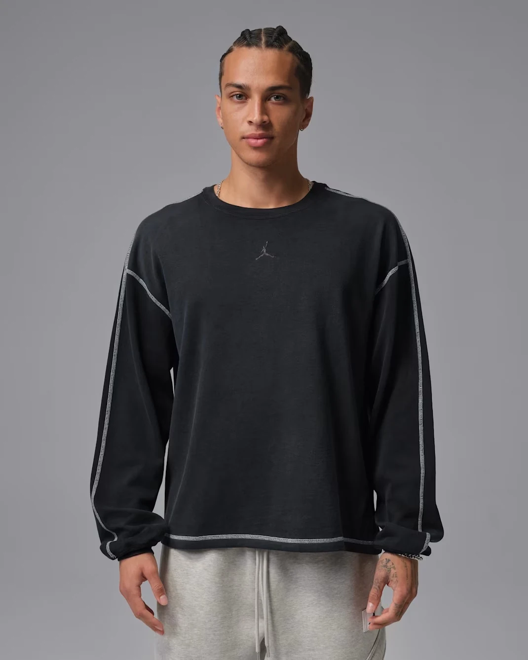 Model wearing the black Jordan Flight heavyweight long-sleeve top with contrast stitching and a small Jumpman logo.