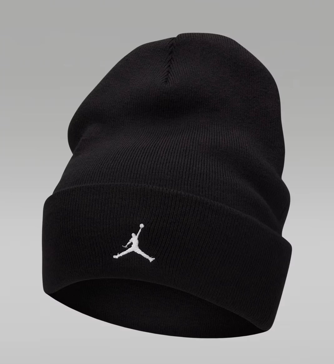 Black Jordan Peak Essential knit beanie with a folded cuff and white embroidered Jumpman logo.