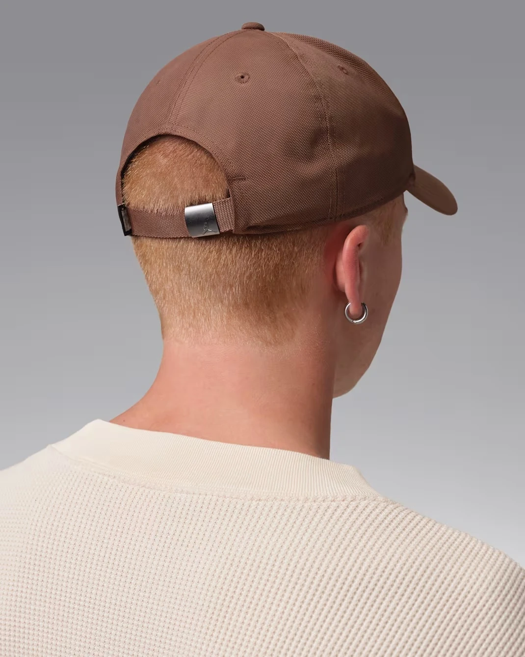 Back view of Fauna Brown Jordan Rise cap showing adjustable strap and metal clasp