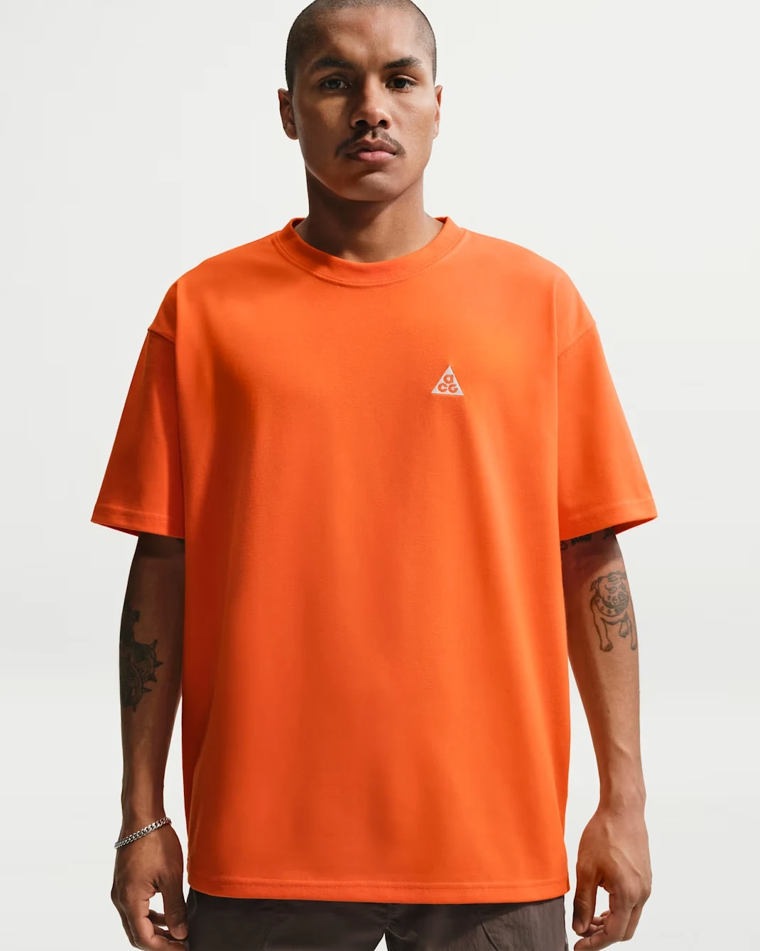 Nike ACG Short-Sleeve T-Shirt in Safety Orange featuring a relaxed fit, crew neckline and small ACG logo on the chest.