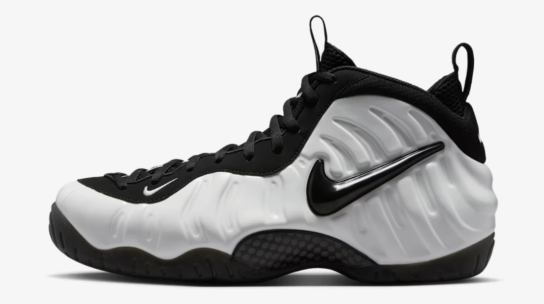 Nike Air Foamposite Pro PRM Summit White sneakers in Summit White and Black with a white Foamposite upper and black Nike Swoosh.