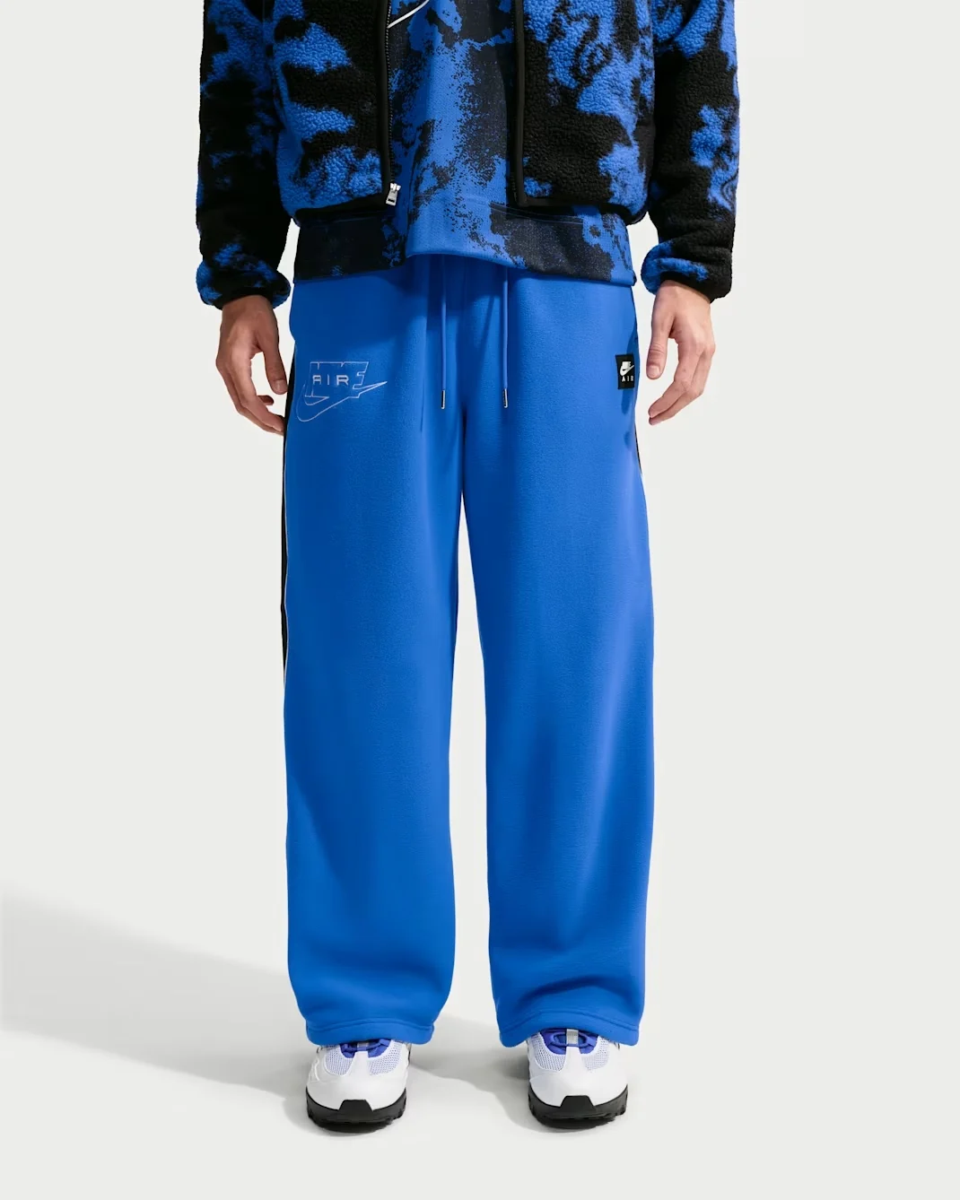Royal blue Nike Air Polartec Therma-FIT open-hem pants with drawstring waist and Nike Air logo