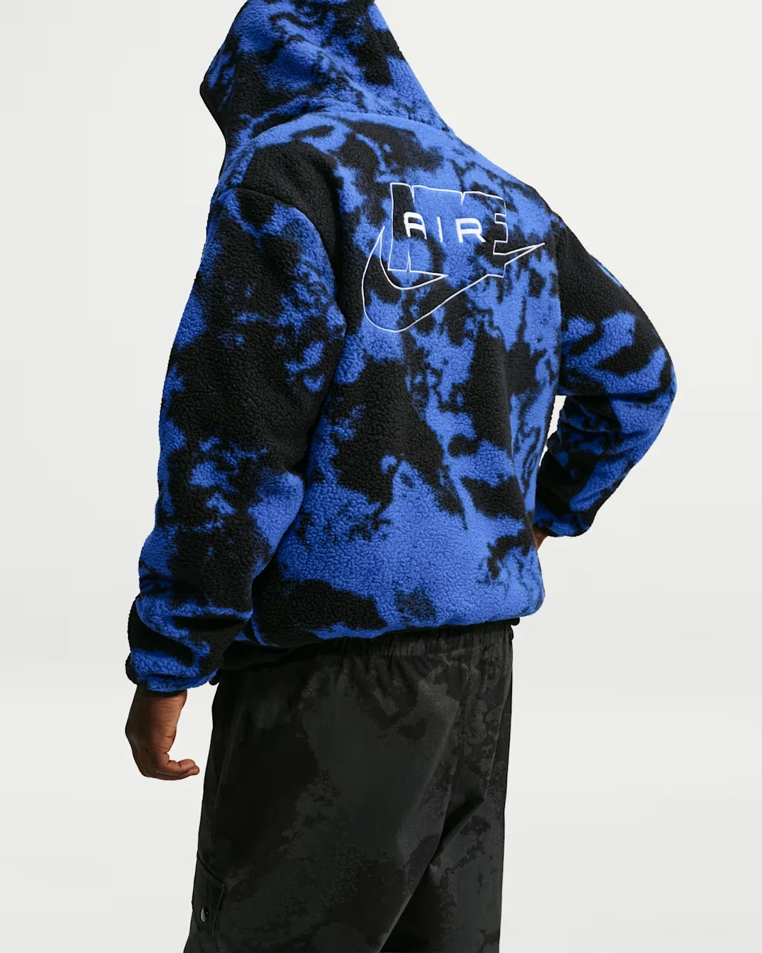 Back view of royal blue and black Nike Air sherpa jacket with white Nike Air graphic