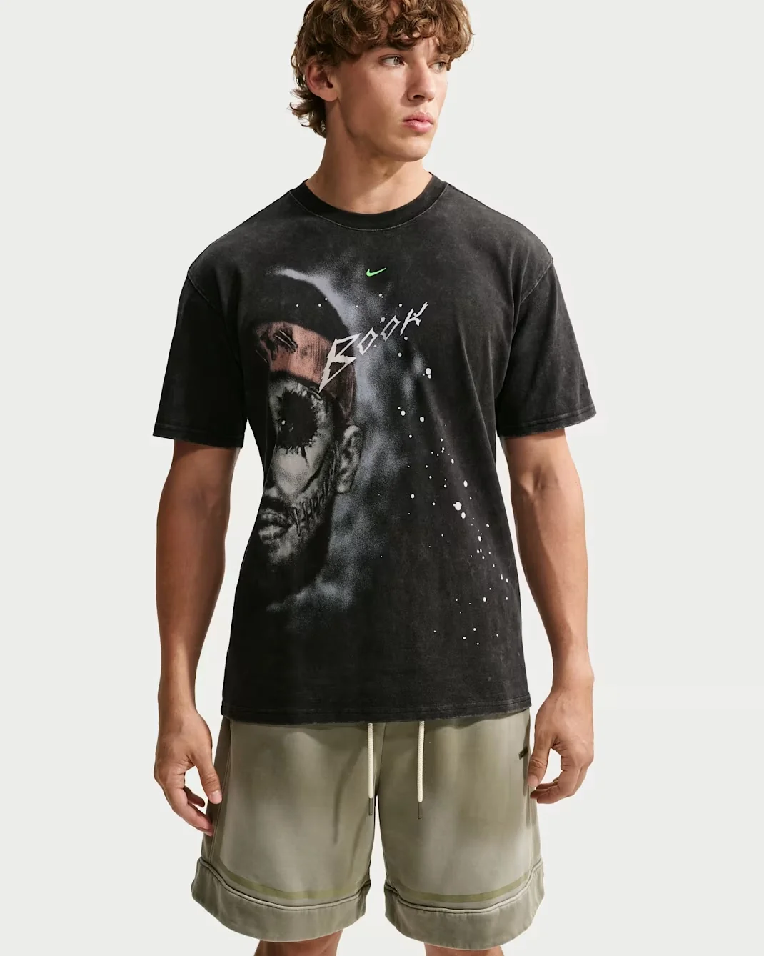 Model wearing the black Nike Book Halloween basketball T-shirt featuring a grey horror-inspired face graphic and white Book lettering.