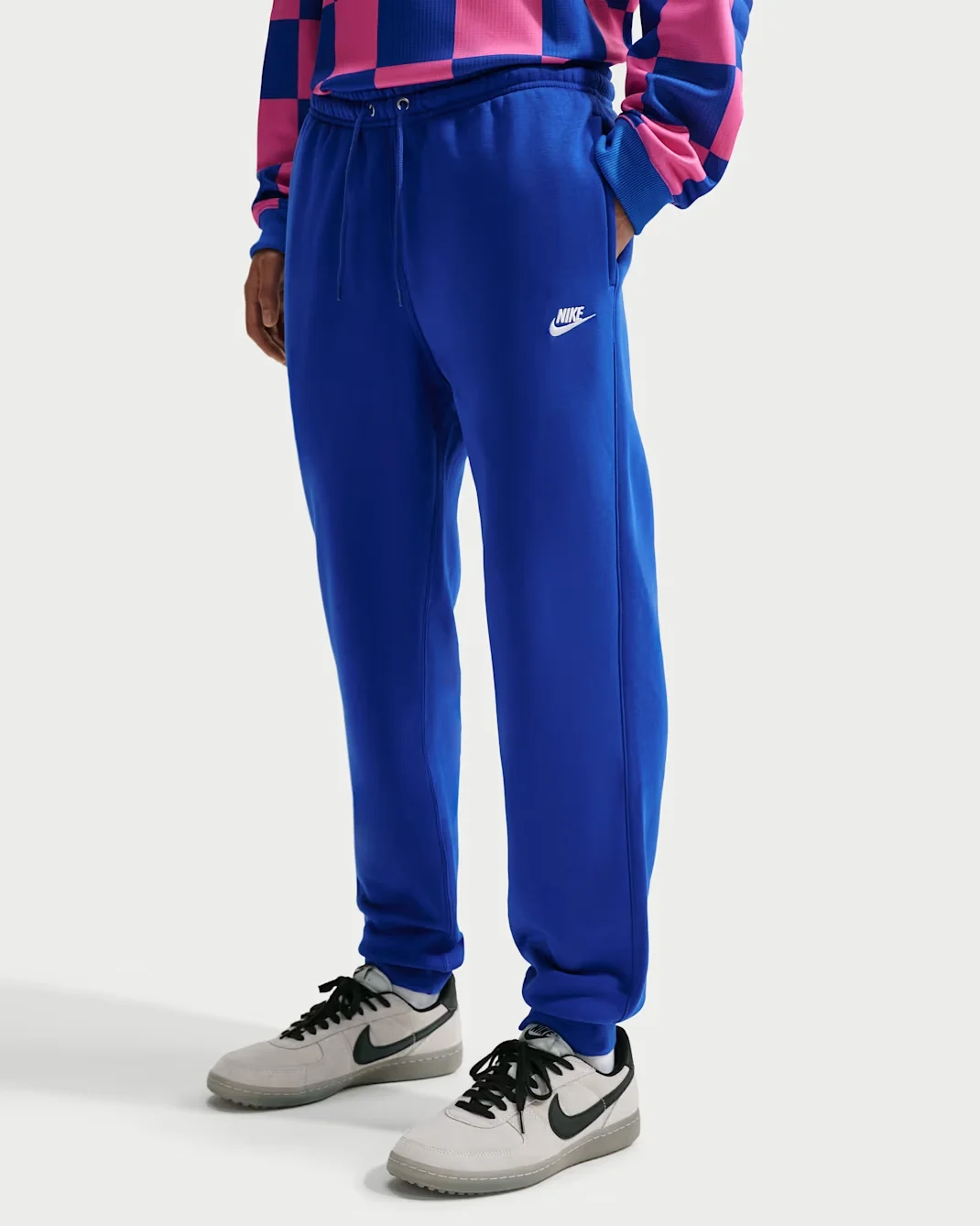 Royal blue Nike Club joggers with tapered legs, drawstring waistband, and white Nike logo