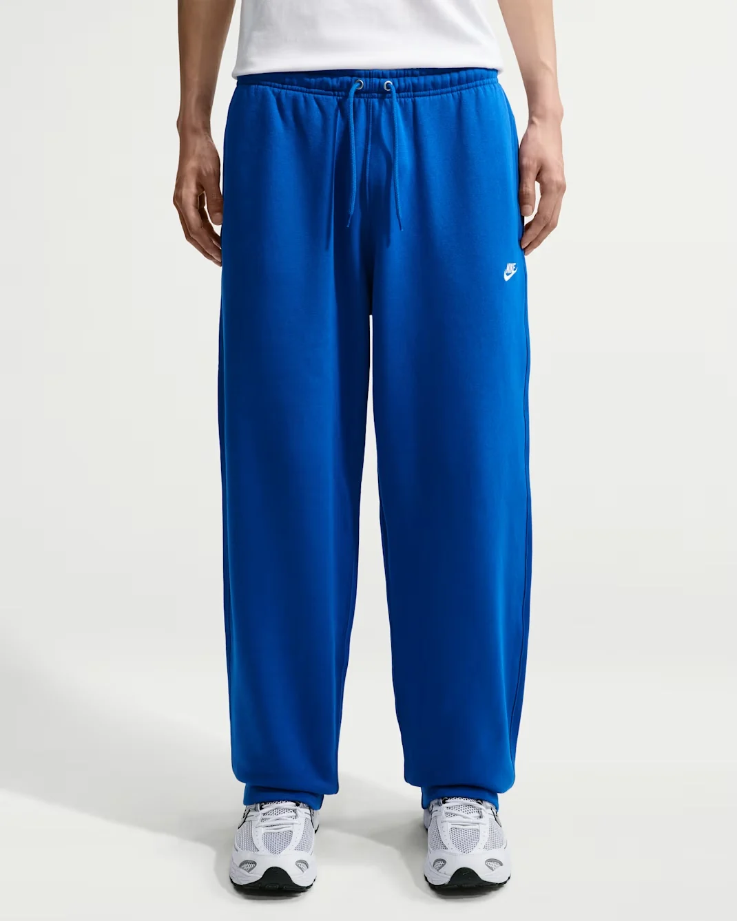 Royal blue Nike Club open-hem fleece pants with relaxed straight-leg fit and white Nike logo