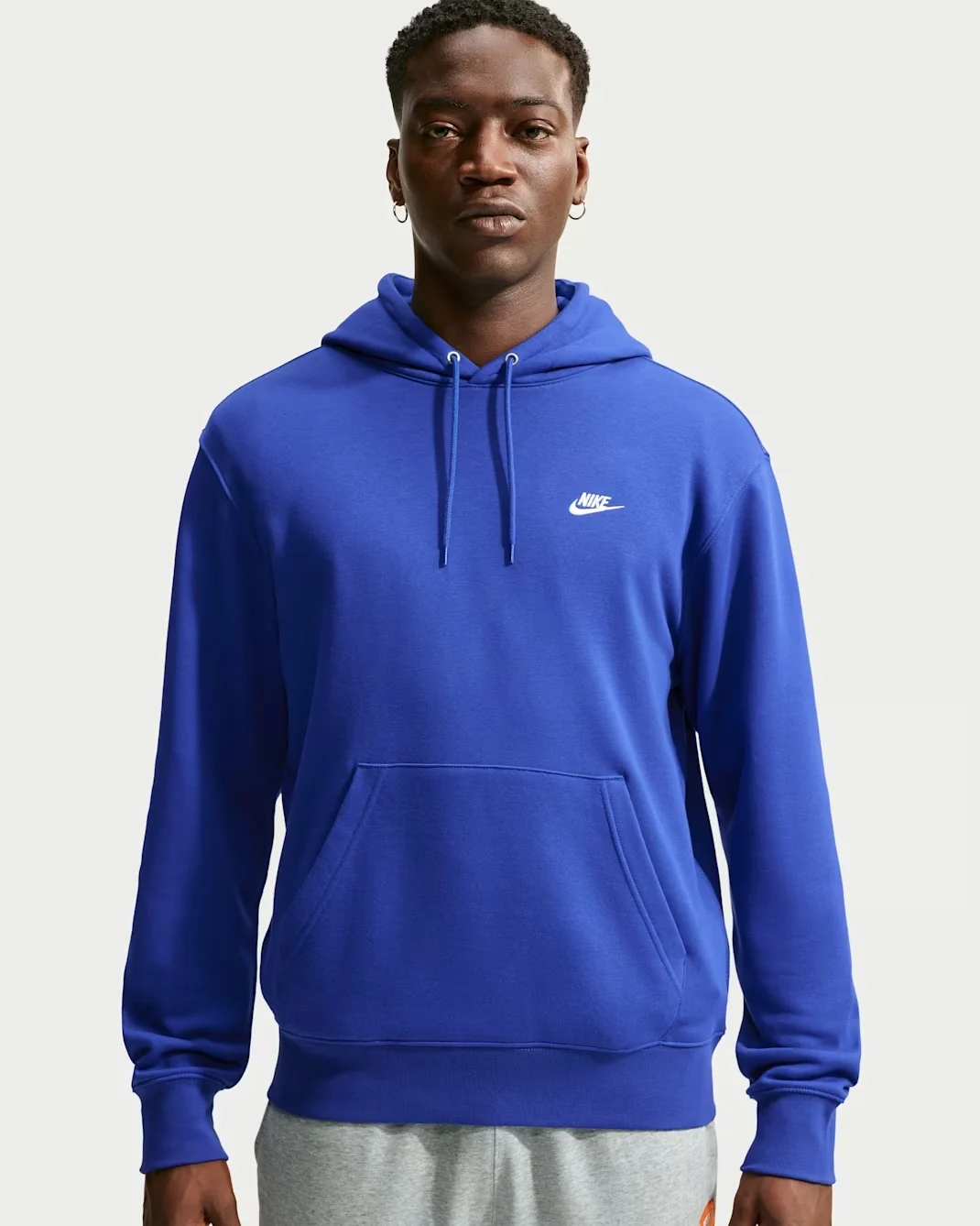 Royal blue Nike Club pullover hoodie with white Nike logo, drawstring hood, and kangaroo pocket