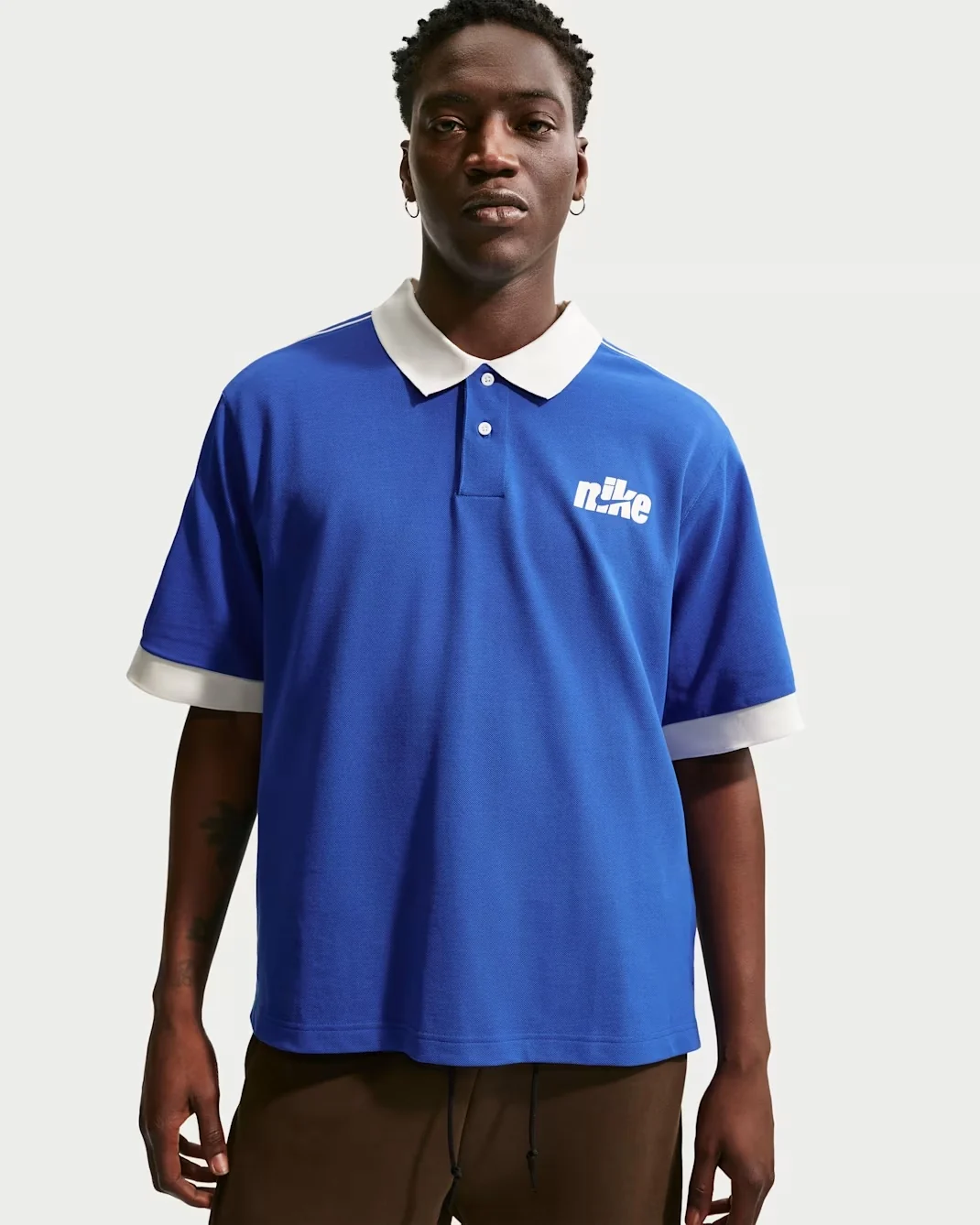 Royal blue Nike Club short-sleeve polo shirt with white collar, sleeve trim, and Nike chest graphic