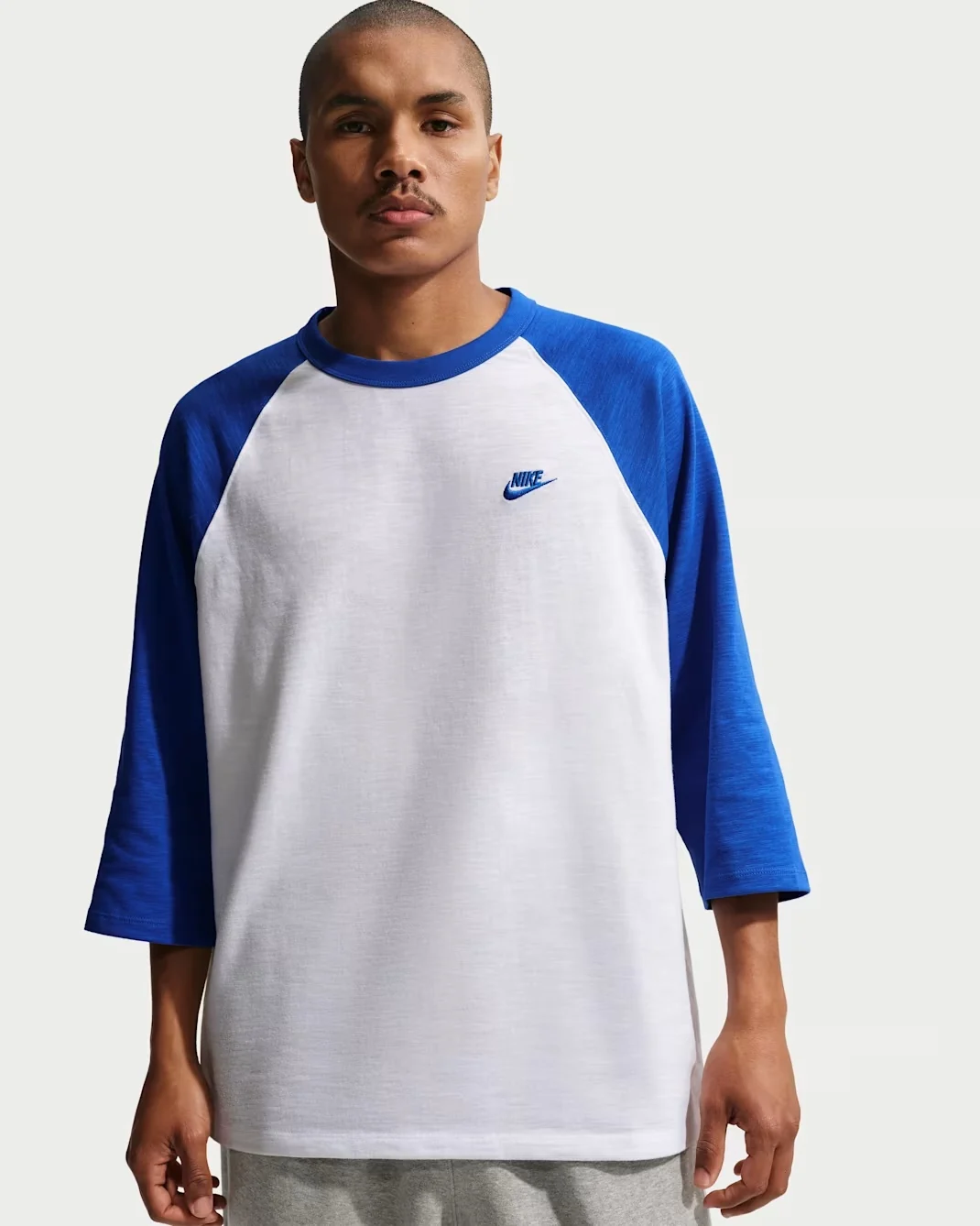White Nike Club raglan shirt with royal blue three-quarter sleeves and embroidered Nike logo