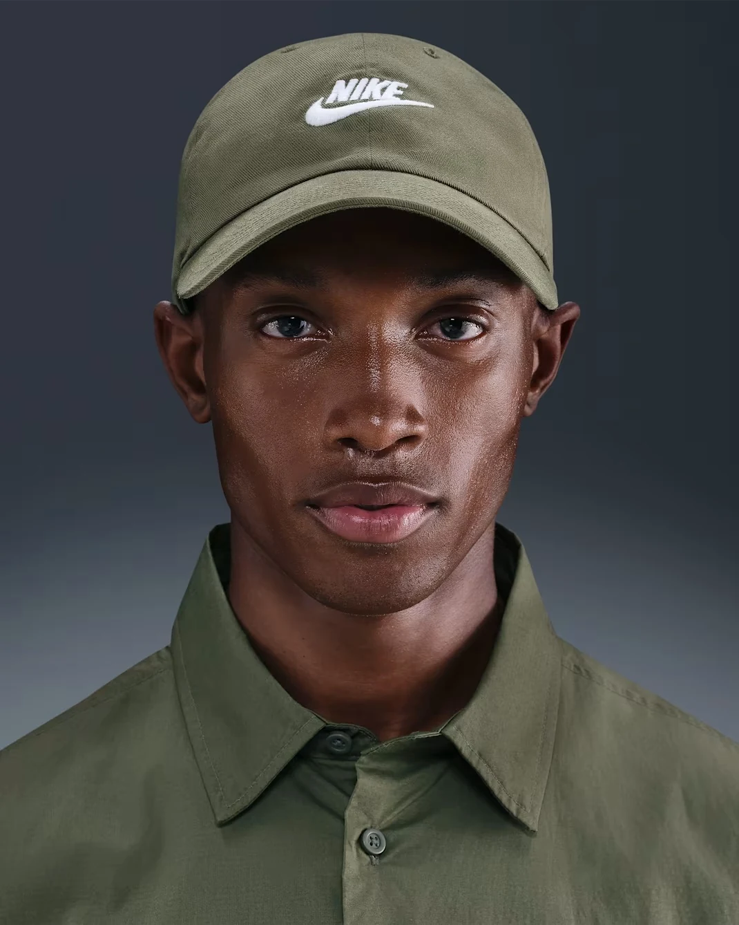 Nike Club Unstructured Futura Wash Cap in Medium Olive featuring a curved bill and embroidered white Nike Futura logo.