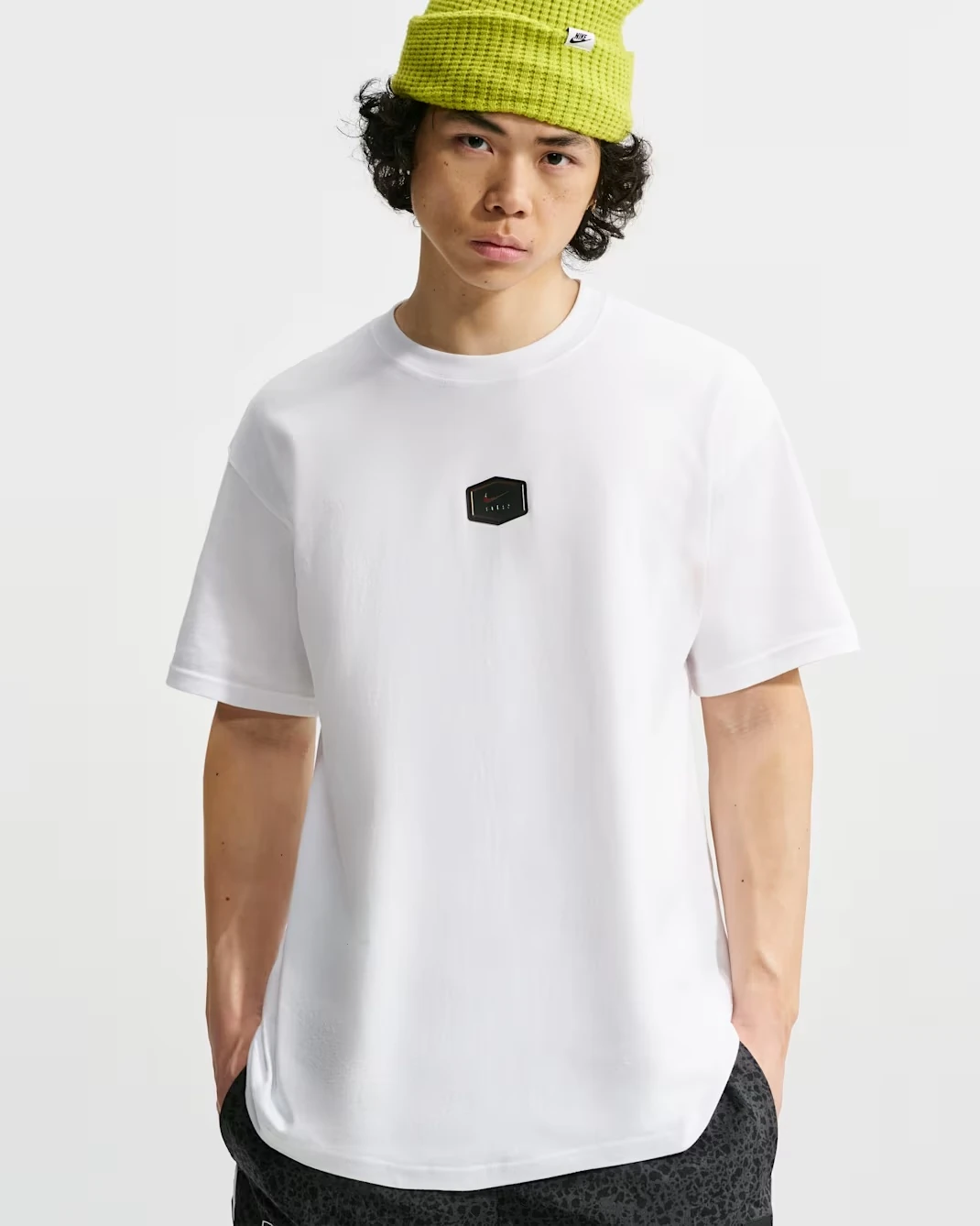 Nike Sportswear men's white T-shirt with small black Nike Air logo patch on the chest.