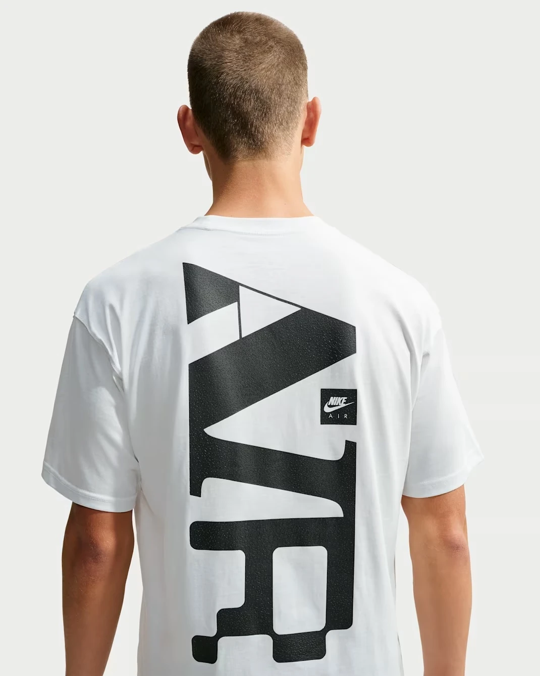 Nike Sportswear Max90 men's Summit White T-shirt featuring an oversized black Nike Air graphic on the back.