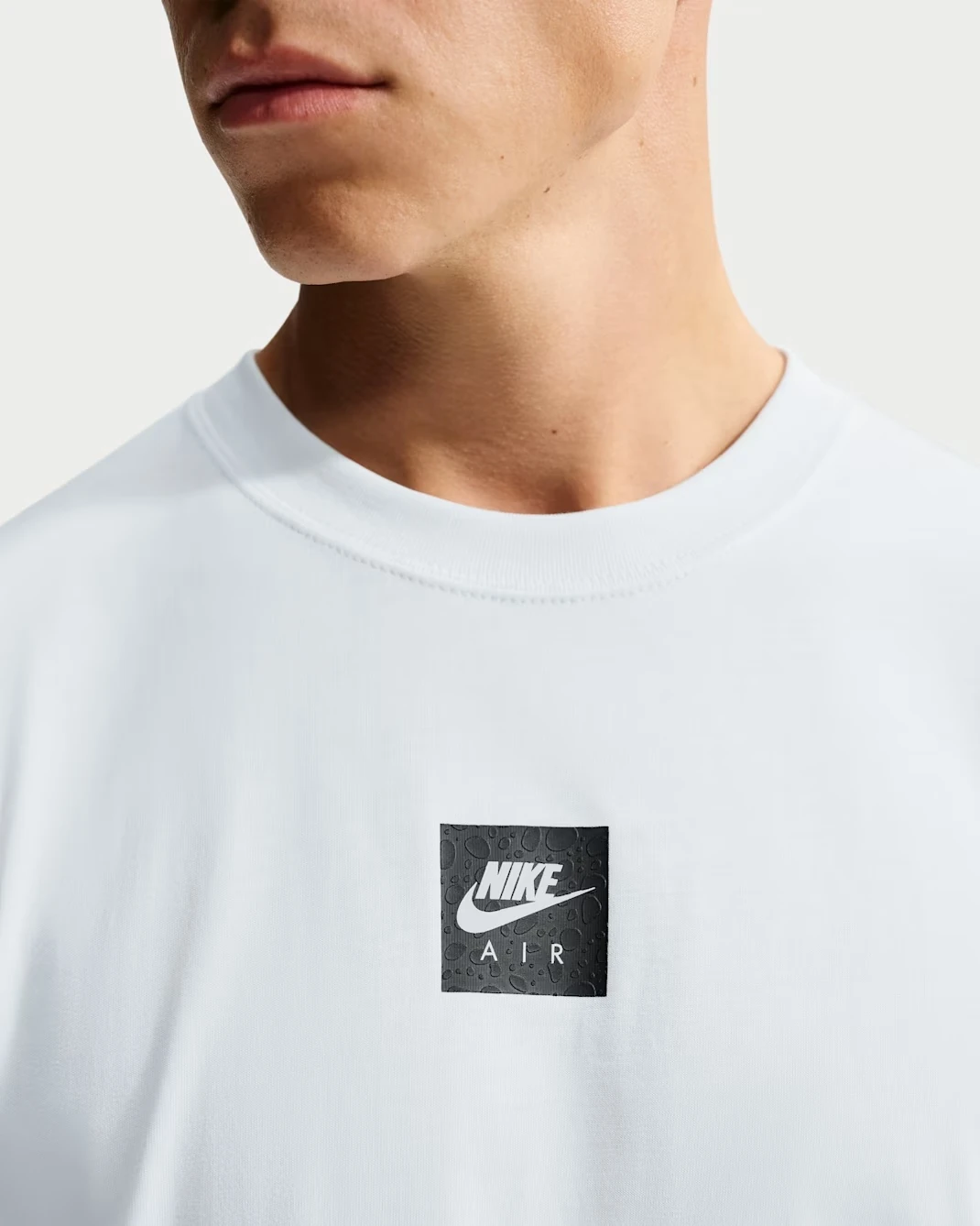 Nike Sportswear Max90 men's Summit White T-shirt with black Nike Air chest graphic.