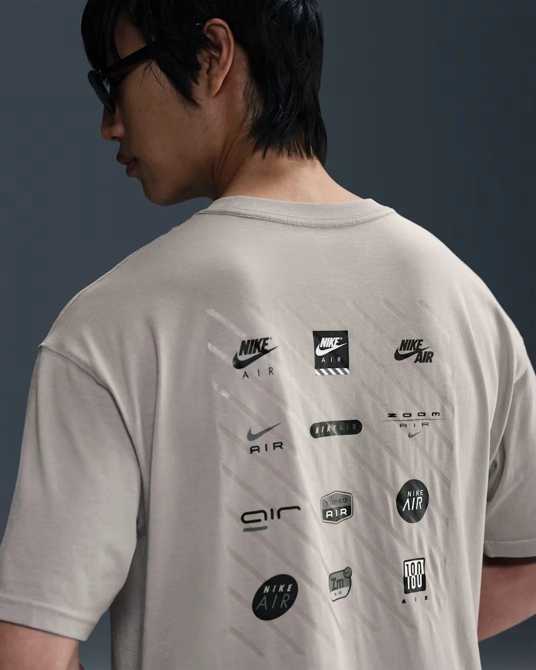Back view of Nike Sportswear Max90 T-shirt in College Grey showing multiple Nike Air graphics