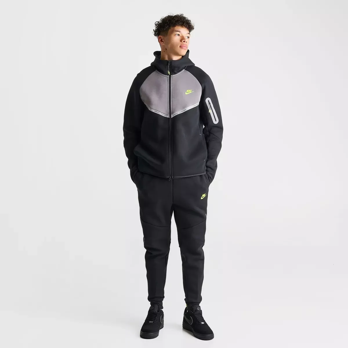 Complete Nike Tech Fleece Reflective outfit in Black, Flat Pewter and Volt featuring the Windrunner hoodie, jogger pants and matching Nike Air Force 1 sneakers.