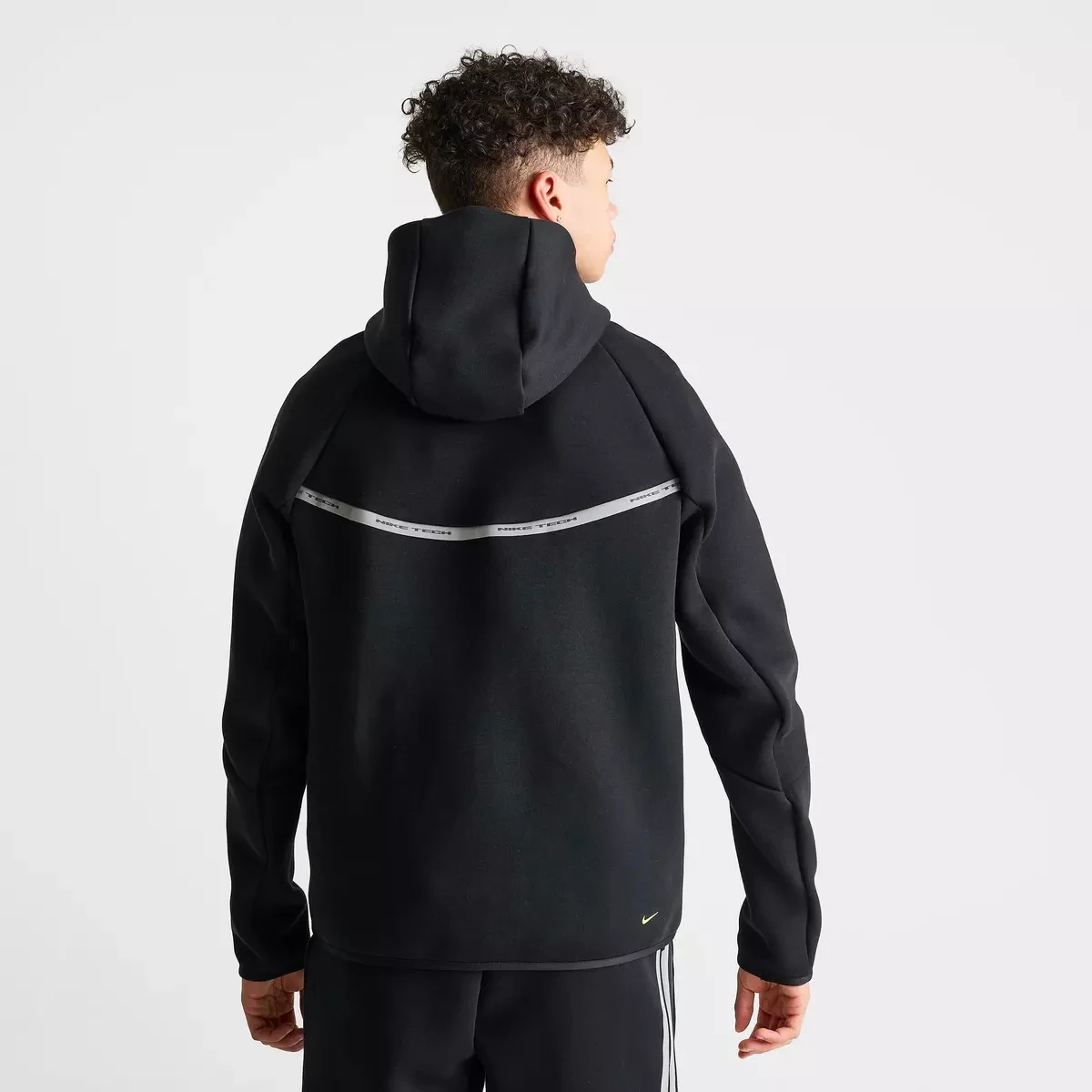 Nike Tech Fleece Reflective Windrunner Full-Zip Hoodie in Black, Flat Pewter and Volt shown from the back with reflective horizontal detailing.