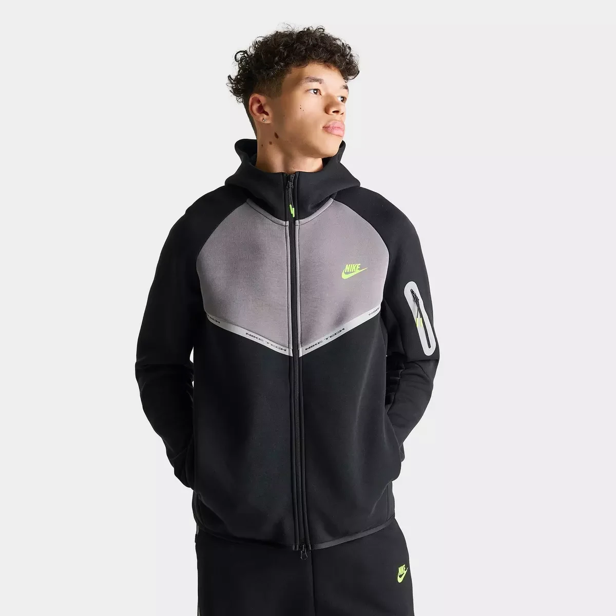 Nike Tech Fleece Reflective Windrunner Full-Zip Hoodie in Black, Flat Pewter and Volt featuring a grey chest panel, reflective detailing and Volt Nike logo.