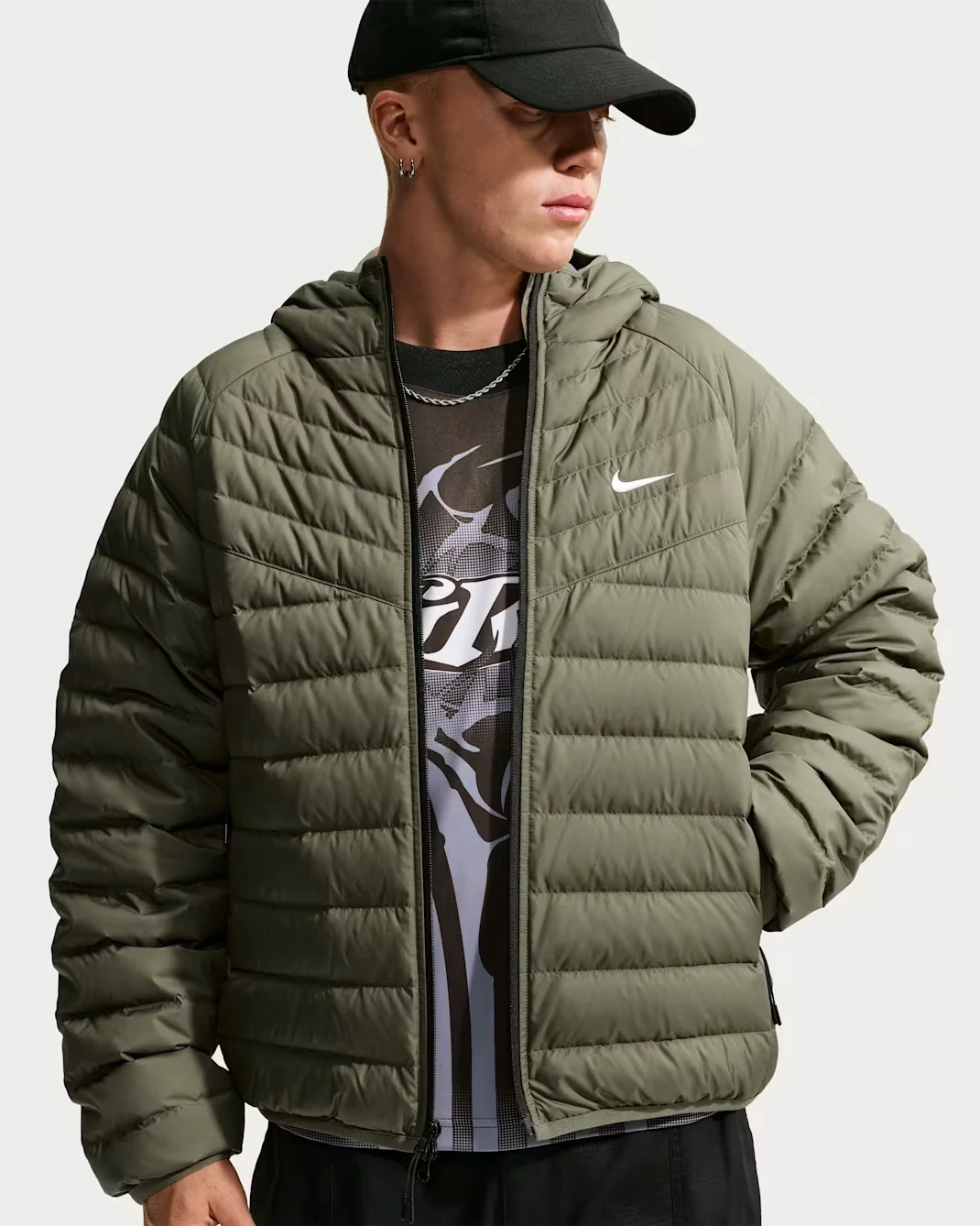 Nike Windrunner Lightweight Down Microchannel Jacket in Medium Olive with quilted insulation, a hood and white Nike Swoosh logo.